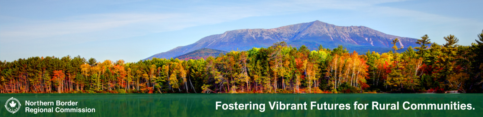 scenic landscape of mountains and forests with NBRC slogan: Fostering Vibrant Futures for Rural Communities